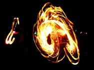 Two fire performers with fire ropes.