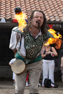 Fire performer amazes all by doing poi in his mouth during a fire show Beamish museum